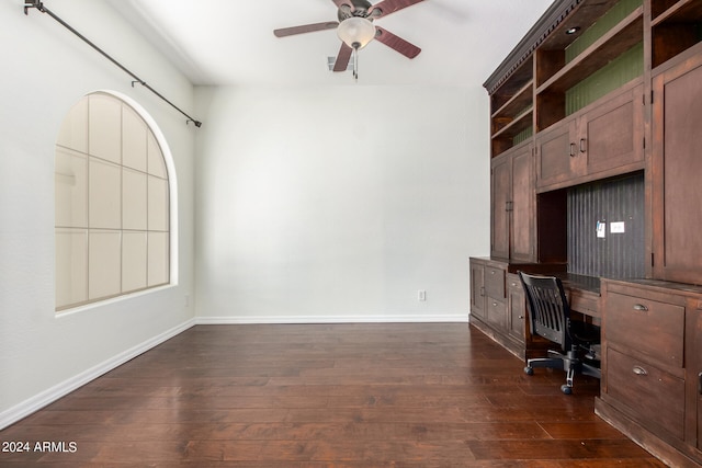 unfurnished office with ceiling fan and dark hardwood / wood-style flooring