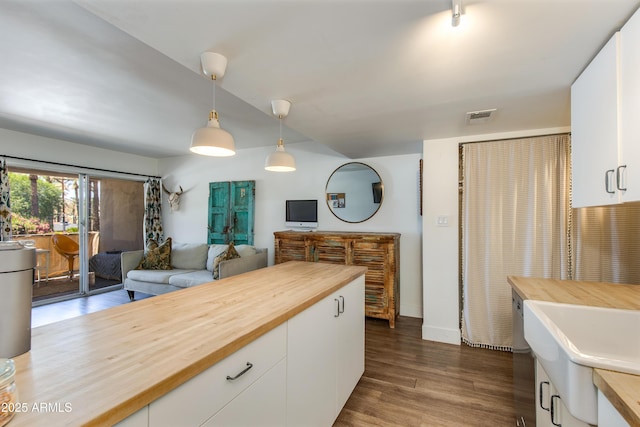 4727 E Lafayette Blvd Unit 211, Phoenix, AZ 85018 - kitchen with butcher block counters, white cabinets, pendant lighting, dark wood-type flooring, and baseboards