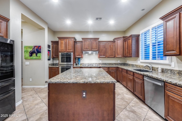 19414 W Pasadena Ave, Litchfield Park, AZ 85340 - kitchen featuring appliances with stainless steel finishes, a center island, a sink, under cabinet range hood, and light tile patterned floors