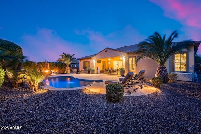 19414 W Pasadena Ave, Litchfield Park, AZ 85340 - pool at dusk with a patio and an outdoor pool
