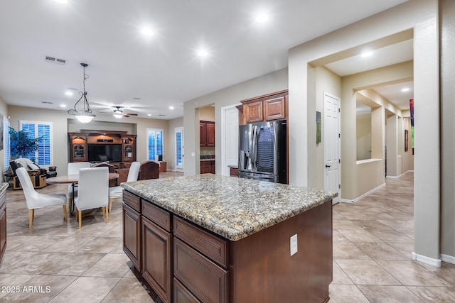19414 W Pasadena Ave, Litchfield Park, AZ 85340 - kitchen featuring stainless steel refrigerator with ice dispenser, a center island, recessed lighting, light stone counters, and a ceiling fan