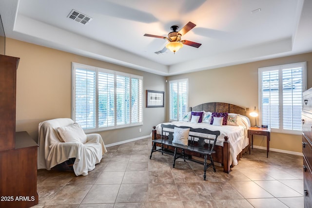 19414 W Pasadena Ave, Litchfield Park, AZ 85340 - bedroom featuring a tray ceiling, baseboards, and a ceiling fan