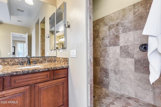 19414 W Pasadena Ave, Litchfield Park, AZ 85340 - bathroom featuring a tile shower and vanity
