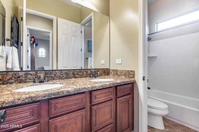19414 W Pasadena Ave, Litchfield Park, AZ 85340 - bathroom featuring toilet, double vanity, and shower / washtub combination
