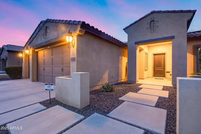 19414 W Pasadena Ave, Litchfield Park, AZ 85340 - view of front facade with concrete driveway, an attached garage, a tile roof, and stucco siding