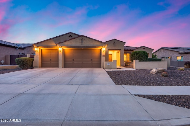 19414 W Pasadena Ave, Litchfield Park, AZ 85340 - view of front of home with an attached garage, driveway, a tile roof, stucco siding, and fence