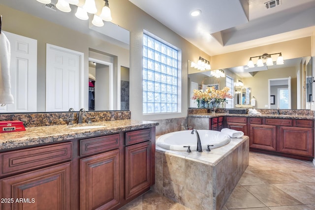 19414 W Pasadena Ave, Litchfield Park, AZ 85340 - bathroom with a garden tub, two vanities, and tile patterned floors