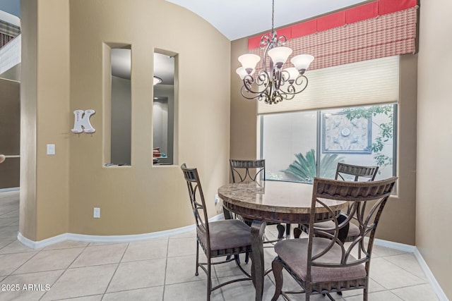 dining room with light tile patterned flooring, a notable chandelier, and baseboards