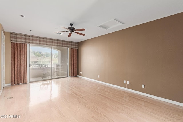 spare room with visible vents, ceiling fan, light wood-style flooring, and baseboards