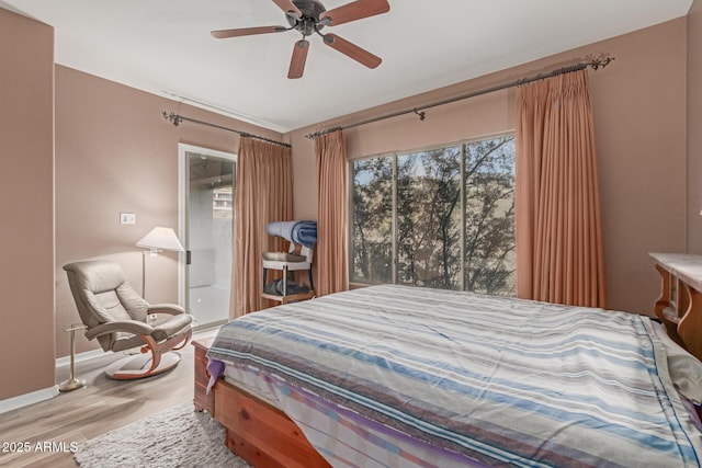 bedroom with ceiling fan, light wood-style flooring, and baseboards