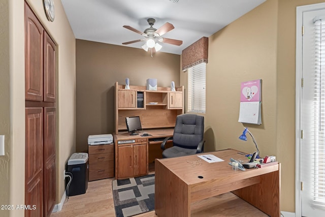 home office featuring light wood finished floors and a ceiling fan