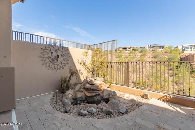 view of patio / terrace featuring fence