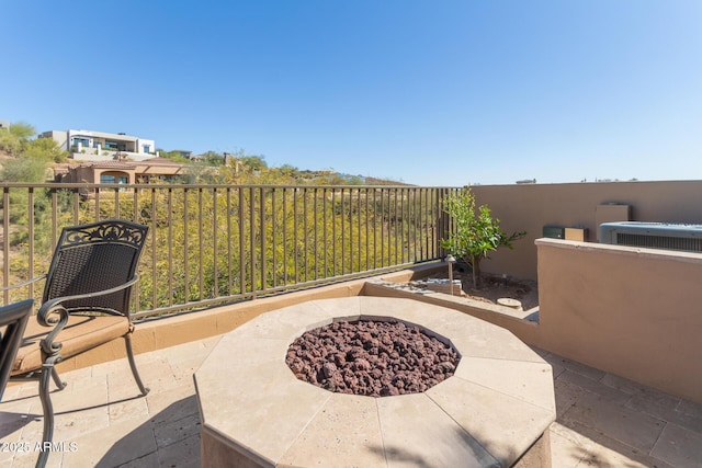 view of patio featuring a fire pit and central AC unit