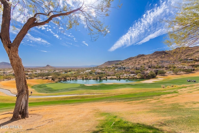 view of property's community featuring view of golf course and a water and mountain view