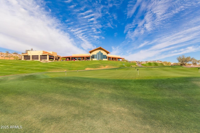 view of property's community featuring golf course view and a lawn