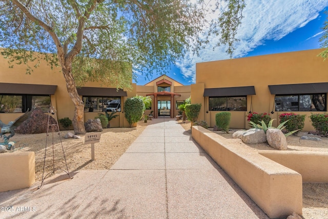 adobe home featuring stucco siding