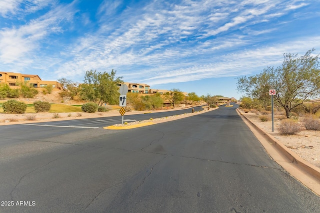 view of road with traffic signs and a residential view