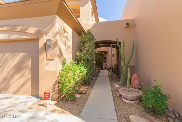 view of exterior entry with stucco siding