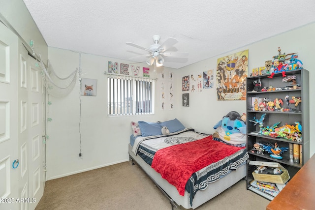 bedroom featuring ceiling fan, a textured ceiling, and carpet