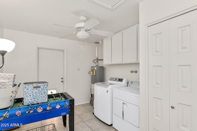 washroom featuring light tile patterned flooring, cabinets, ceiling fan, washer and clothes dryer, and water heater