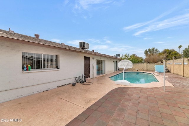 view of pool with central AC and a patio