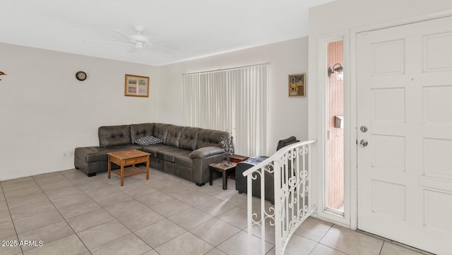 living room featuring light tile patterned floors and ceiling fan