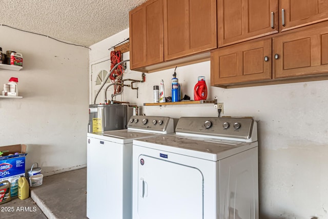 clothes washing area with washing machine and clothes dryer, water heater, cabinets, and a textured ceiling