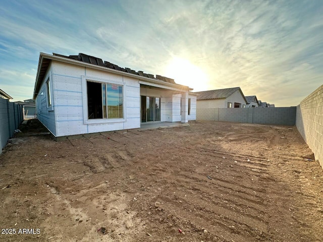 view of back house at dusk