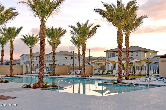 pool at dusk with a patio