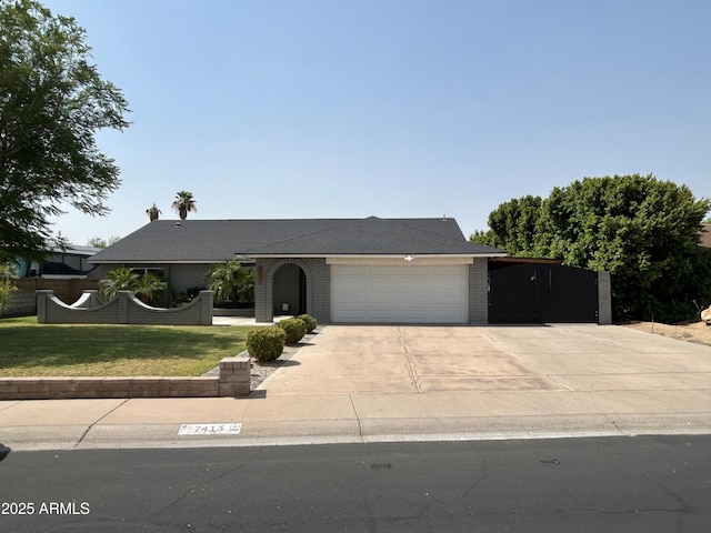 7413 W Columbine Dr, Peoria, AZ 85381 - ranch-style home featuring driveway, a garage, a front lawn, and brick siding