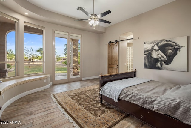 6861 W Calle Lejos, Peoria, AZ 85383 - bedroom featuring a barn door, access to outside, light wood finished floors, and recessed lighting