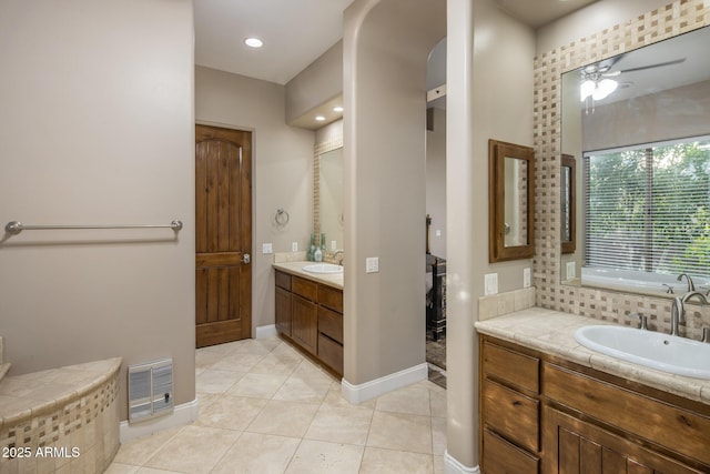6861 W Calle Lejos, Peoria, AZ 85383 - bathroom with two vanities, tile patterned flooring, ceiling fan, and tiled tub