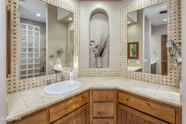 6861 W Calle Lejos, Peoria, AZ 85383 - bathroom featuring tasteful backsplash, vanity, walk in shower, and a tub to relax in