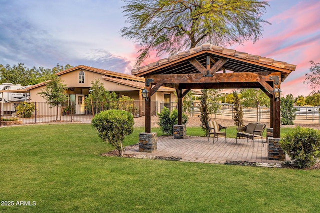 6861 W Calle Lejos, Peoria, AZ 85383 - yard at dusk featuring a gazebo and a patio