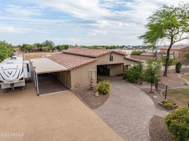6861 W Calle Lejos, Peoria, AZ 85383 - view of front of property with decorative driveway, a tiled roof, stucco siding, and a carport