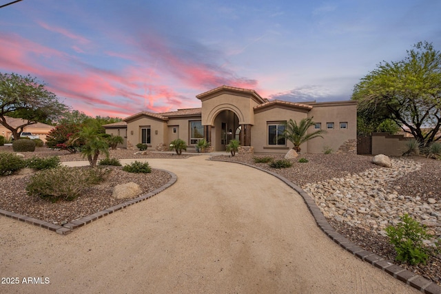 6861 W Calle Lejos, Peoria, AZ 85383 - mediterranean / spanish-style home with stucco siding, curved driveway, and a tile roof