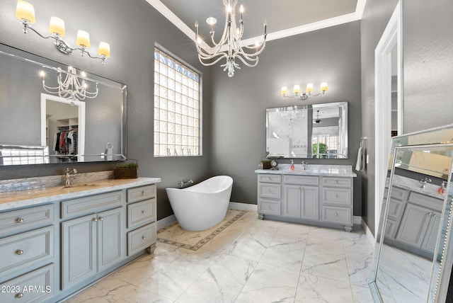 bathroom featuring ornamental molding, vanity, and a bathing tub