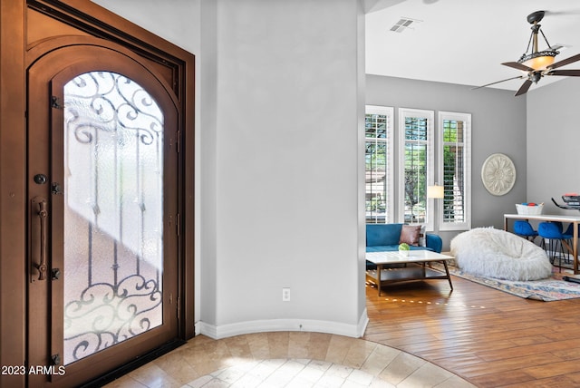 foyer with light hardwood / wood-style floors and ceiling fan