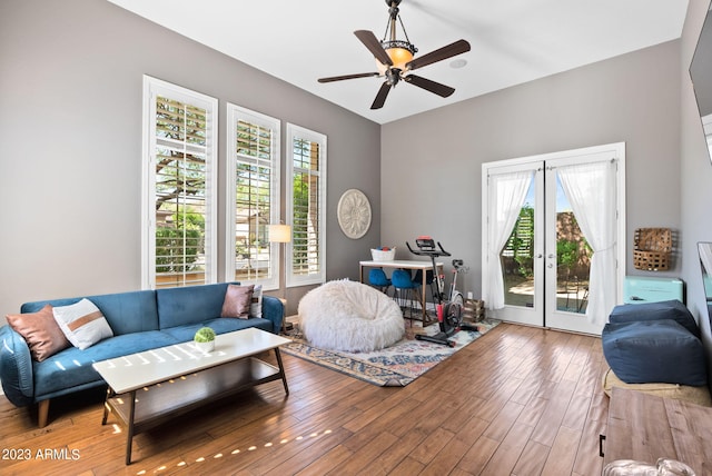 living room featuring ceiling fan and hardwood / wood-style flooring