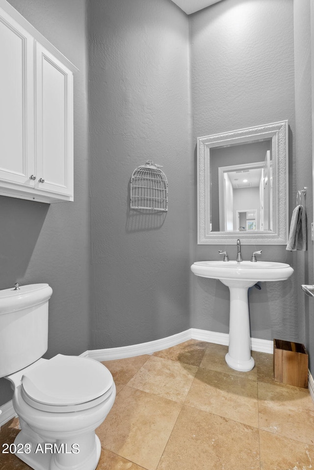 bathroom featuring sink, tile patterned floors, and toilet