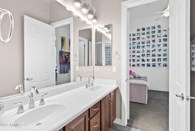 bathroom with ceiling fan and vanity