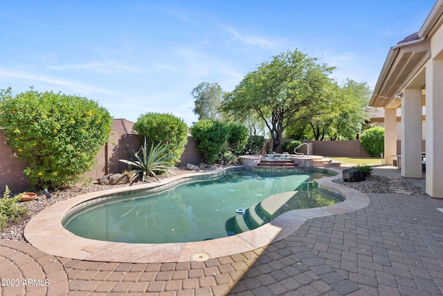 view of pool with an in ground hot tub and a patio area