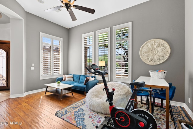 living room with ceiling fan and hardwood / wood-style floors