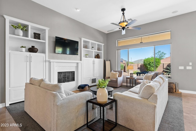 tiled living room featuring ceiling fan