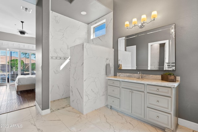 bathroom featuring a tile shower, hardwood / wood-style flooring, and vanity