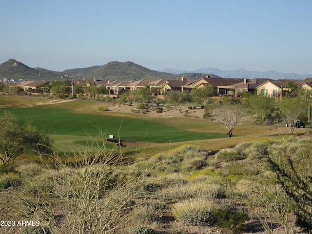 view of property's community with a yard and a mountain view