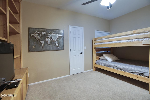 bedroom featuring ceiling fan, light carpet, and baseboards