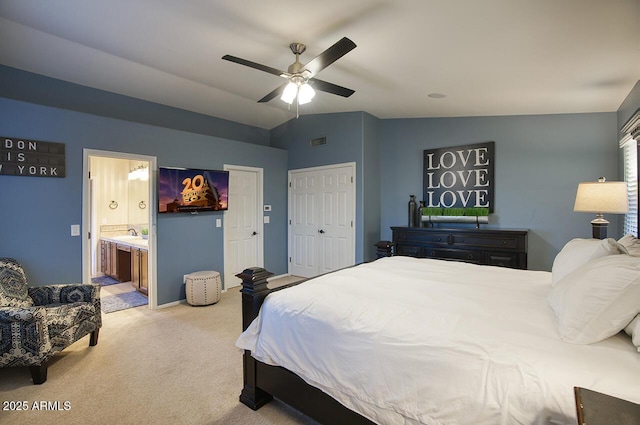 bedroom with ensuite bath, visible vents, vaulted ceiling, carpet floors, and a ceiling fan