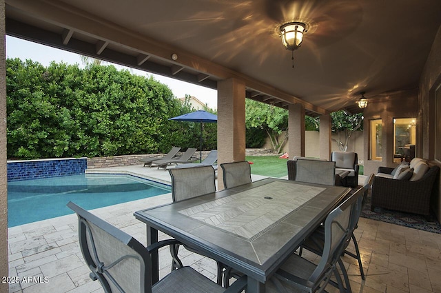 view of patio / terrace with outdoor dining space, an outdoor pool, and outdoor lounge area