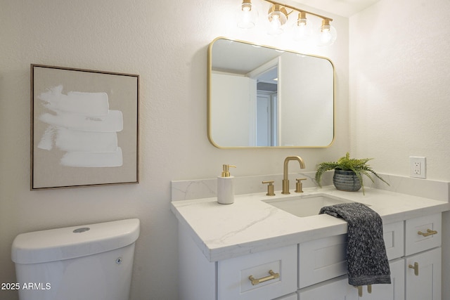 bathroom with toilet and vanity